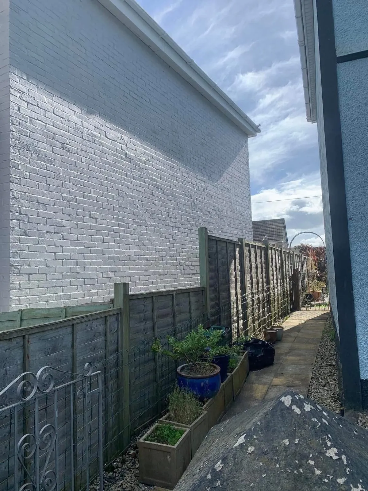 Freshly painted brick wall after preparation and masonry paint in Porthleven